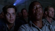 Tim Robbins and Morgan Freeman in a movie theatre. 