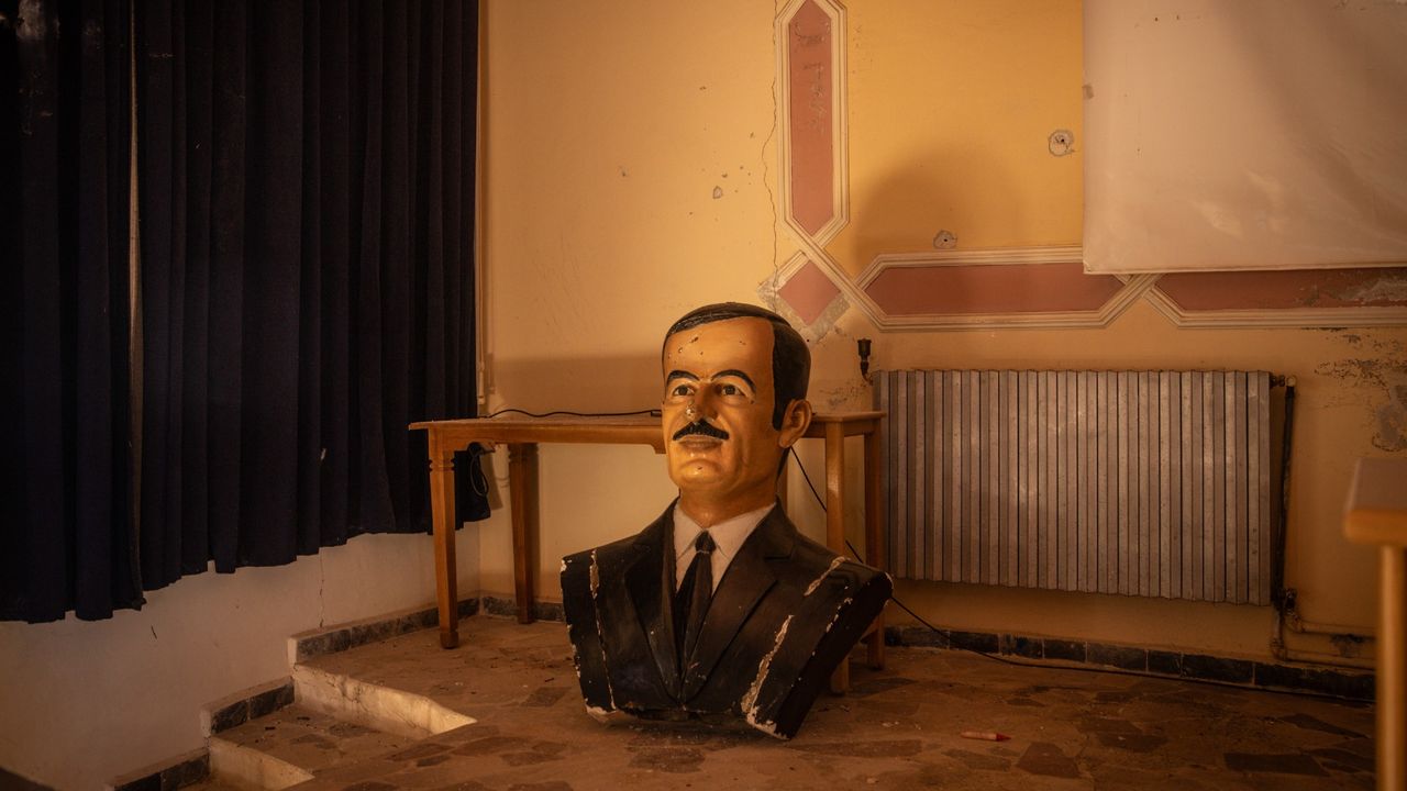 A defaced bust of Syria&#039;s former dictator Hafez al-Assad, father of Bashar al-Assad, at a military base in Damascus