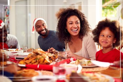 multi-generational family sitting at table enjoying Christmas dinner