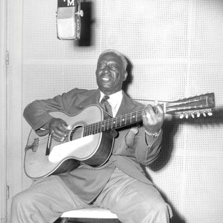 Folk and blues singer and guitarist Huddie Ledbetter, a.k.a. Lead Belly, in the C.P. MacGregor recording studio circa 1944 in Los Angeles, California.