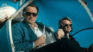 Robert Vaughn and David McCallum wear sunglasses as they fly in a helicopter in The Man From UNCLE series finale.