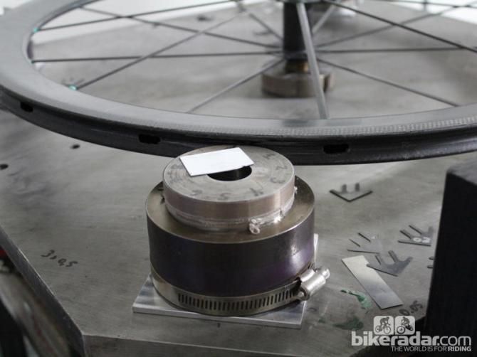 After the spokes and carbon nipples are set in the wheel - which has no tension - the wheel is trued with concentric dials and heat