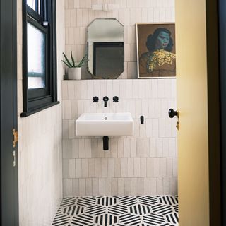 Bathroom with tiled walls and monochrome tiled floor