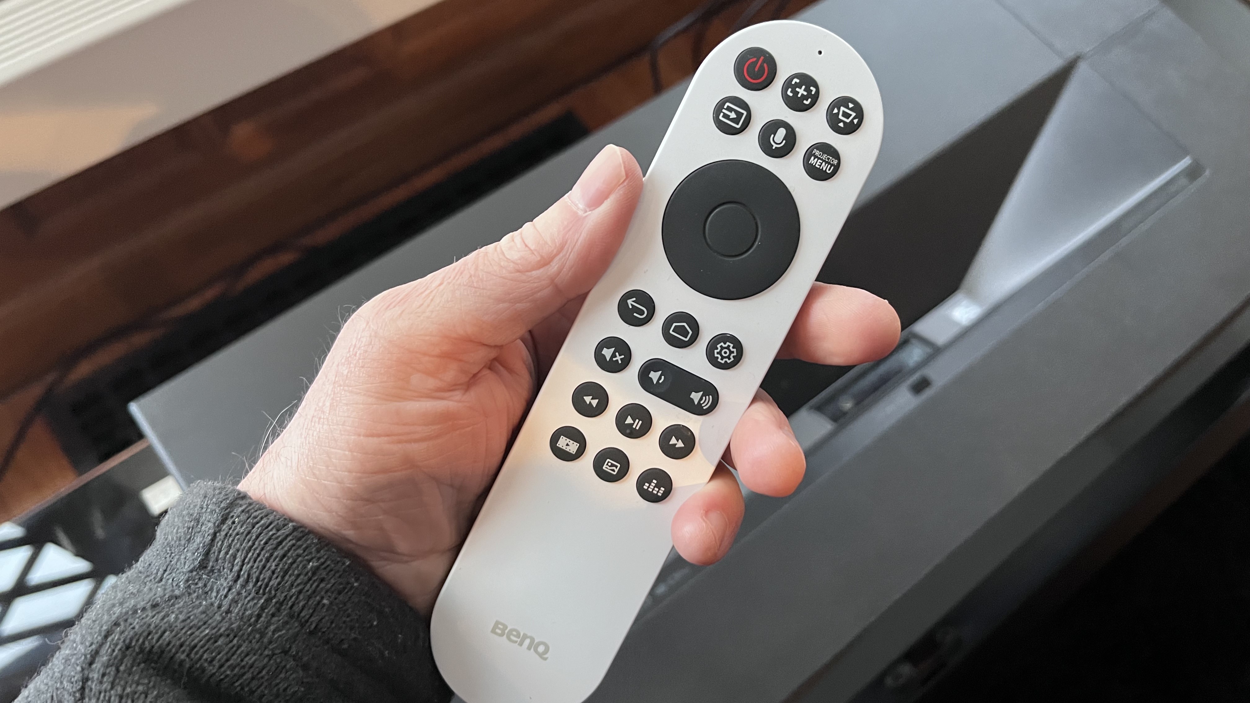 BenQ v5000i projector remote control in reviewer's hand