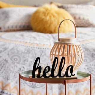 bedroom with hello sign and lantern