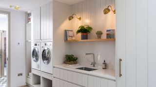 laundry room with wall lights switched on