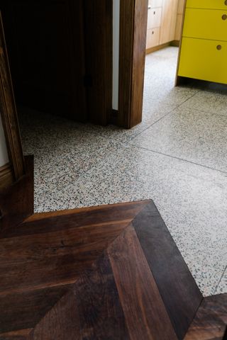 wood and tile parquet flooring transition by The Brownstone Boys