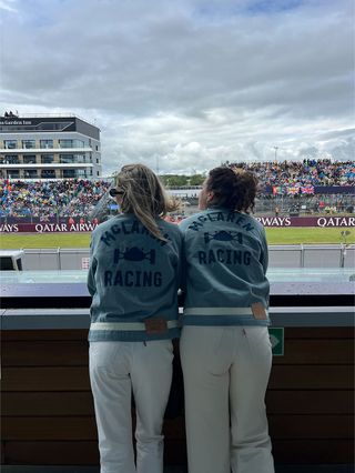 Eliza Huber and friend wearing denim Levi's x McLaren jackets and white jeans at the British Grand Prix.