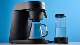 the ratio four coffee maker photographed against a blue tom's guide background 