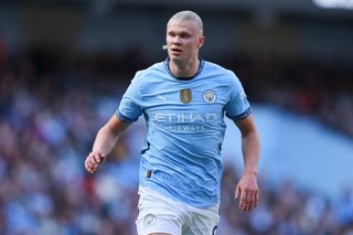 Manchester City striker Erling Haaland playing in the Premier League as he walks