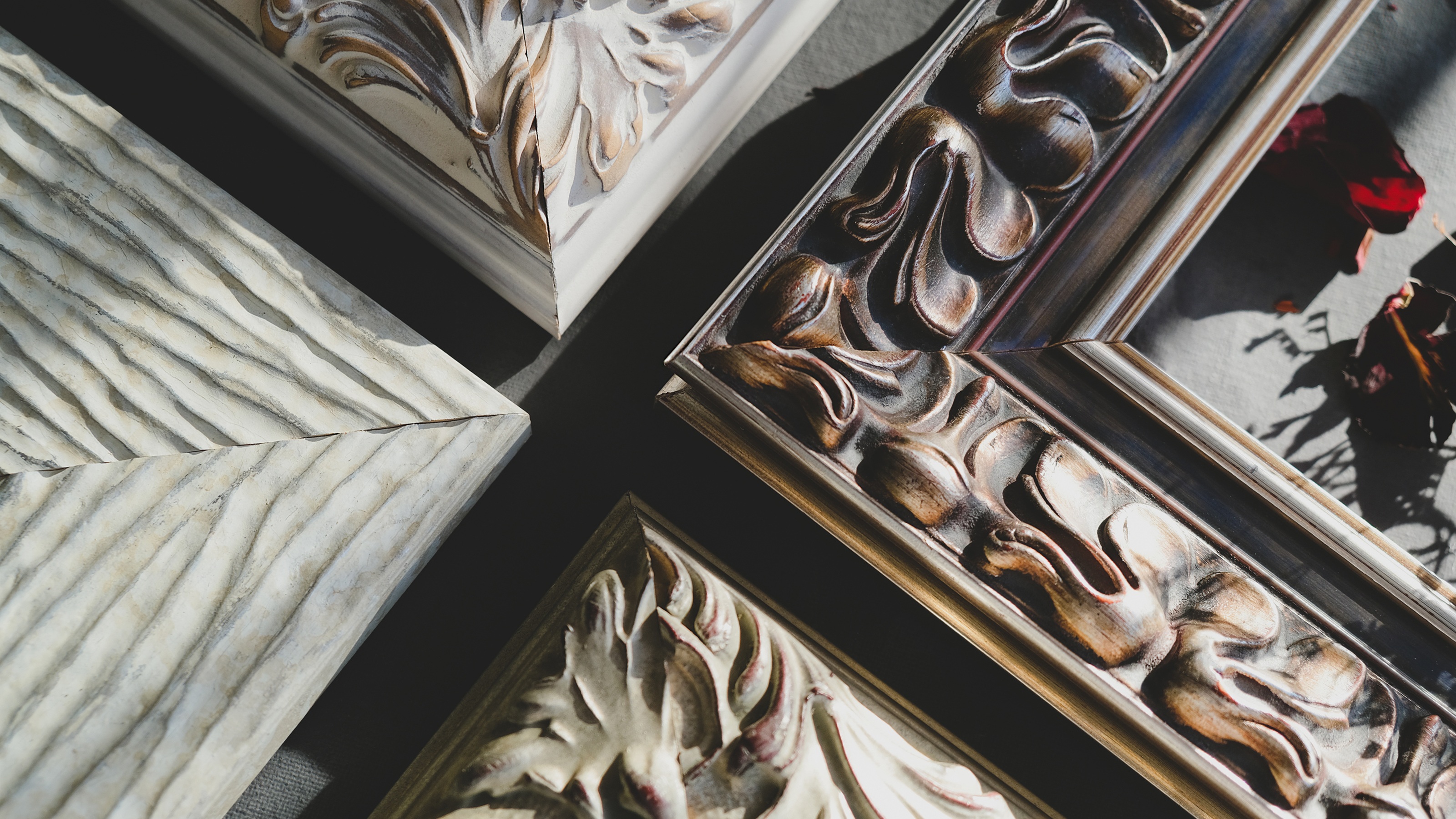 The corners of four different ornate picture frames.