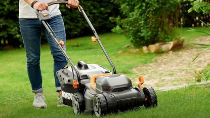 A Worx WG779 mower cutting grass