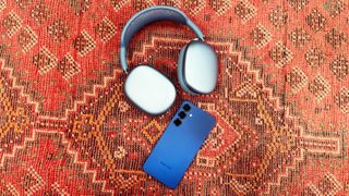 the airpods max 2 and samsung galaxy s25+ on a red rug
