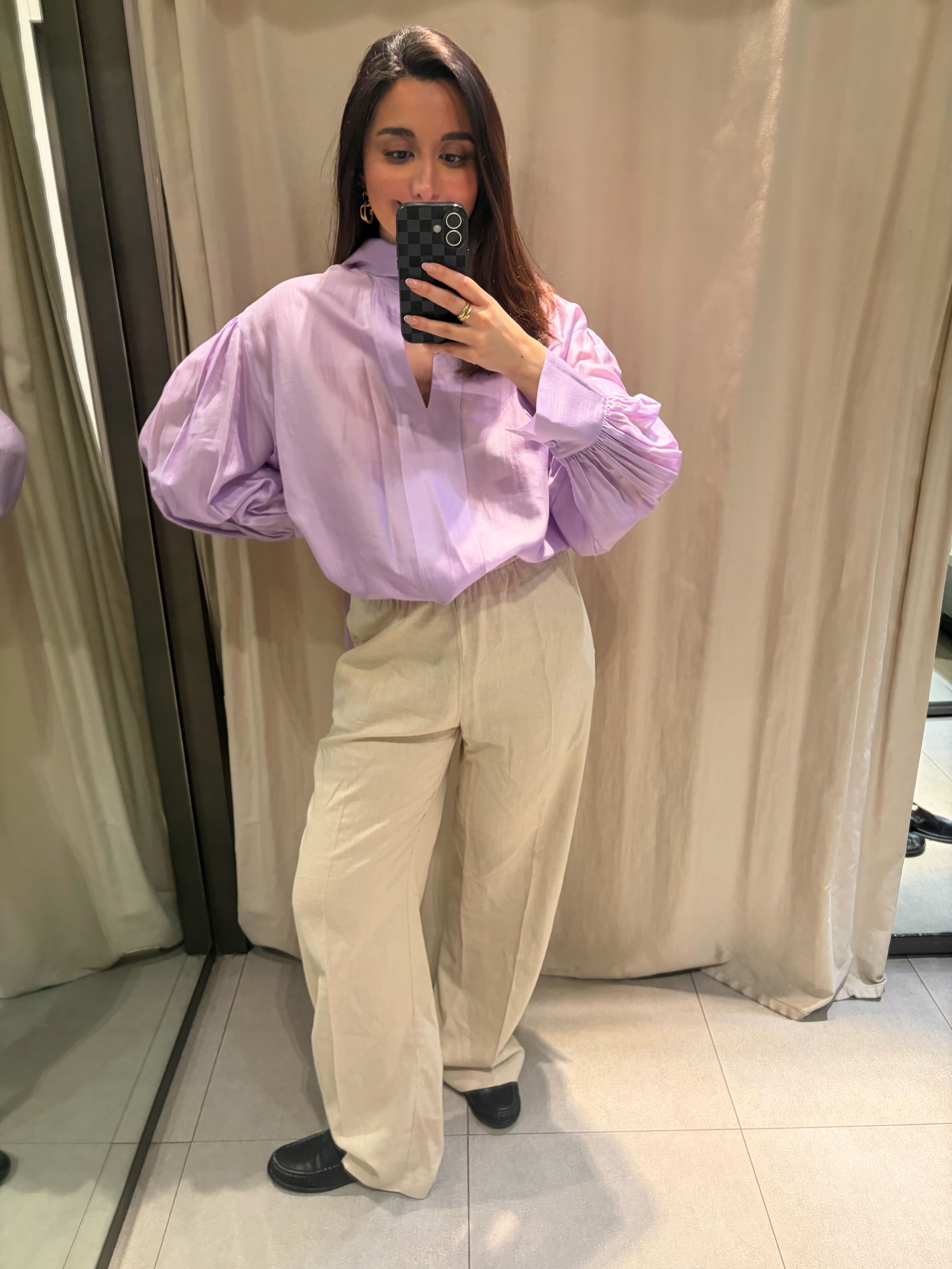 marina wearing linen trousers and purple blouse