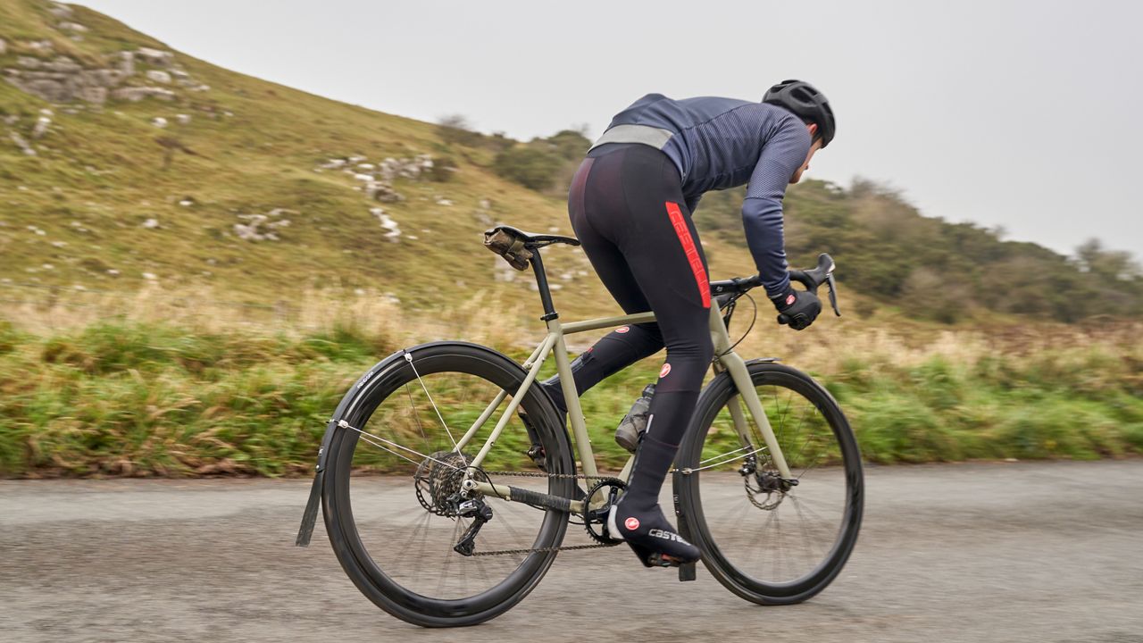 Image shows a cyclist riding with one of the best saddle bags