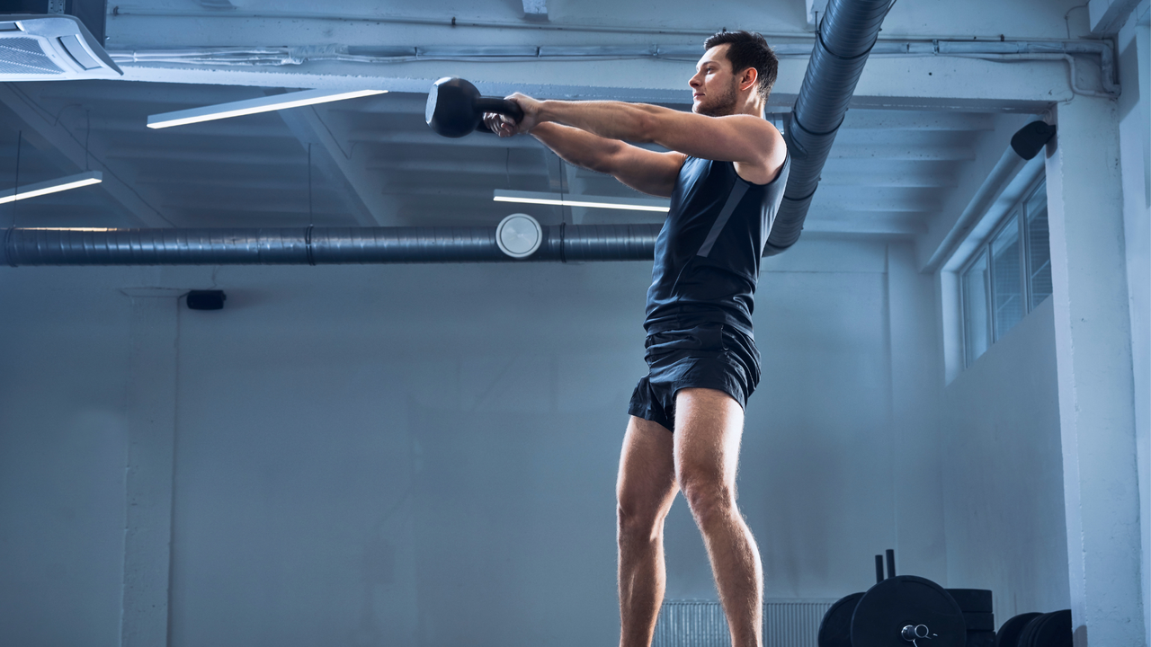 Man performing a kettlebell swing