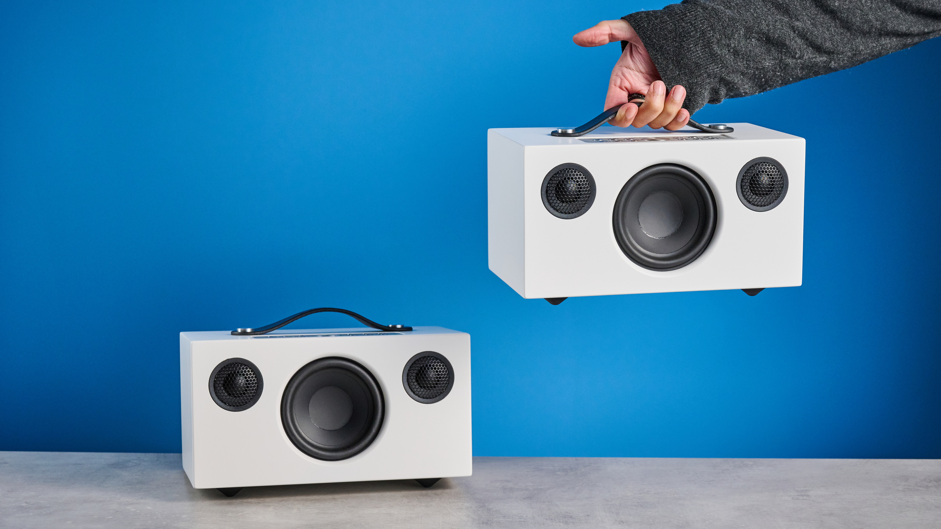 Audio Pro C5 MKII Bluetooth speaker in white photographed on a blue background