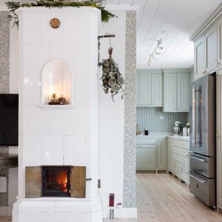 original white tiled swedish fireplace decorated for christmas