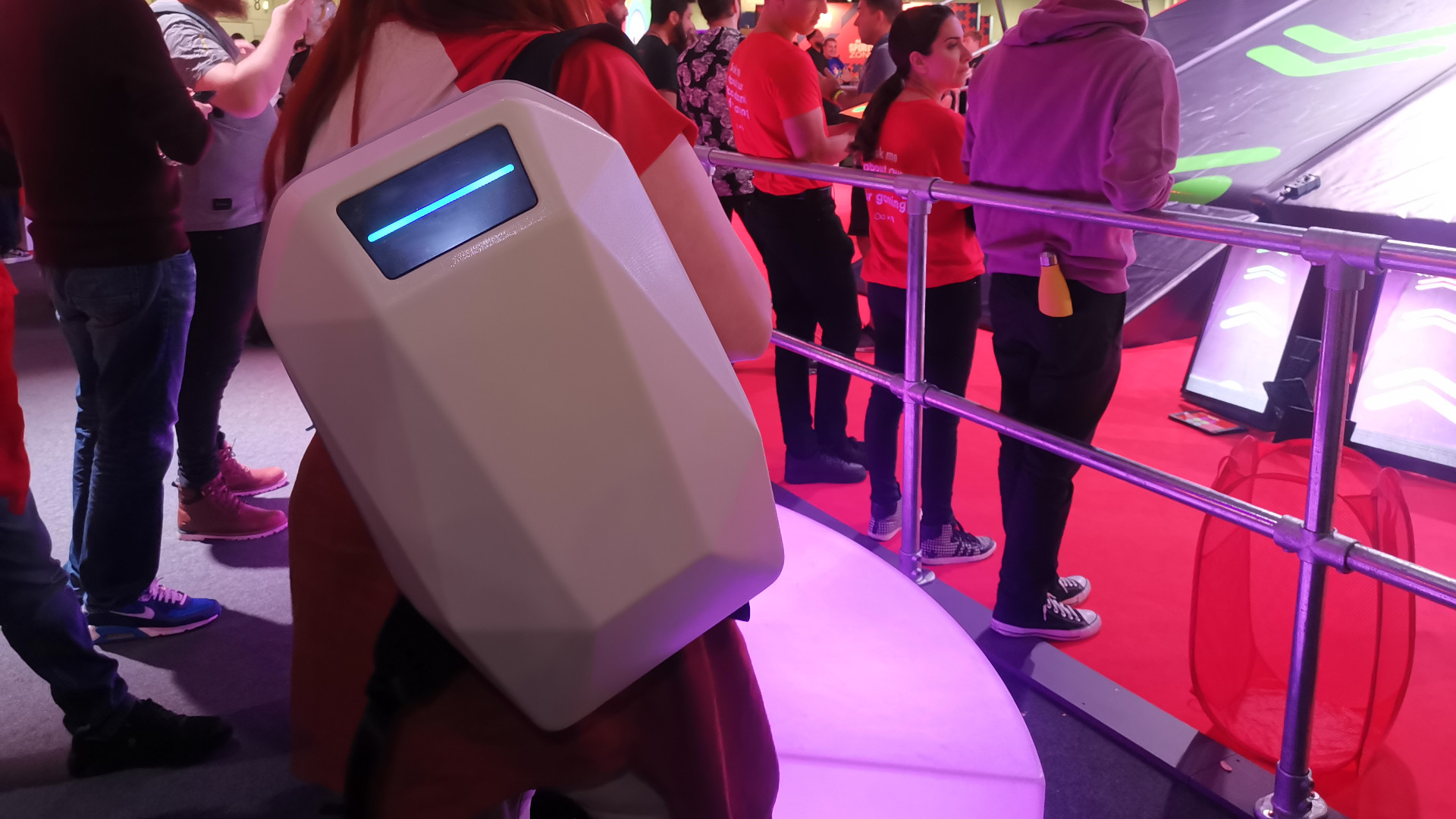 A white Tajezzo PZ5 backpack being modelled in a dimly lit event