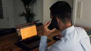 Man Calling while looking at Email