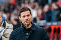 Xabi Alonso looking stern during a football match on the sidelines.