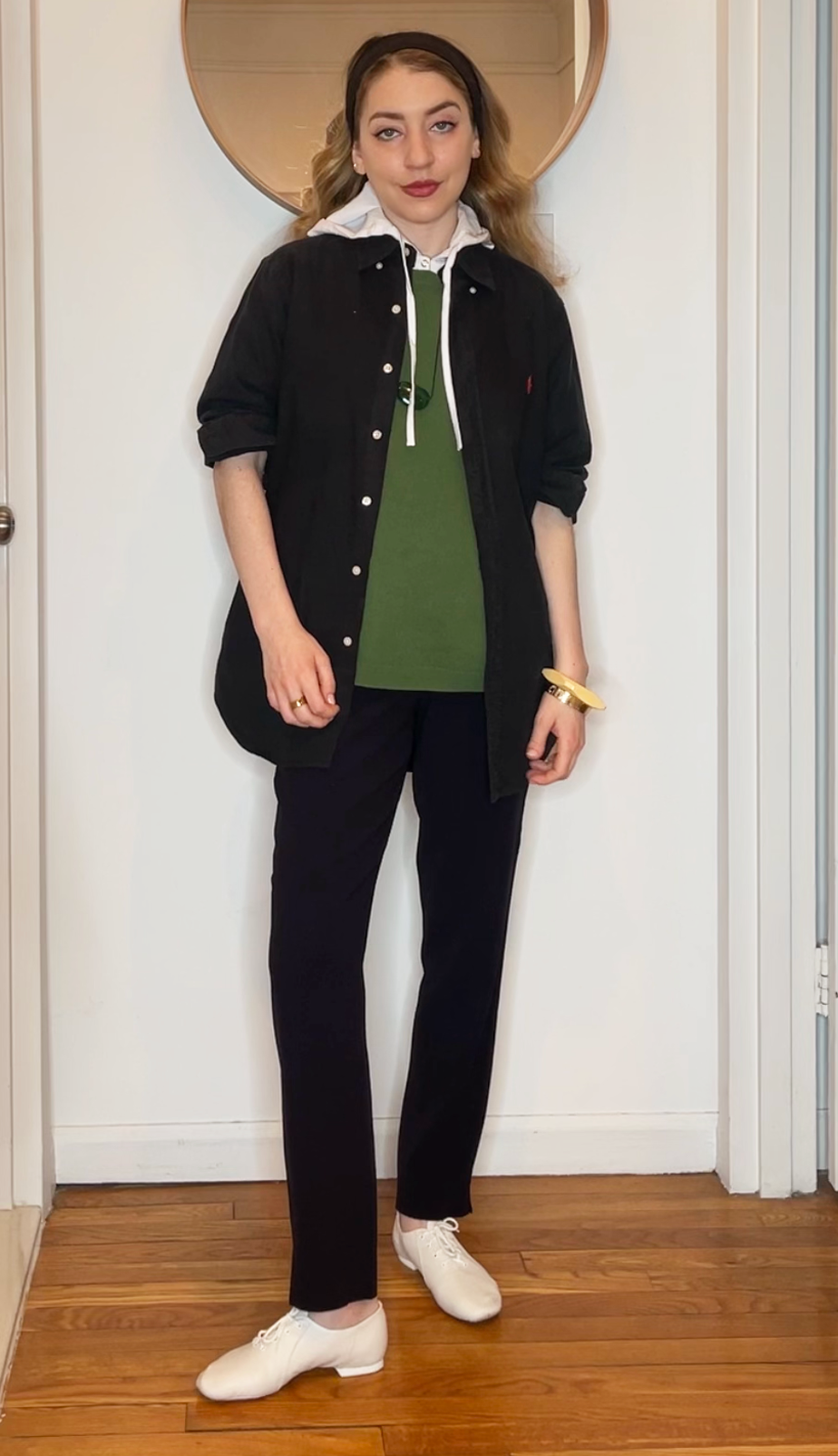 Elizabeth Cardinal Tamkin wears a neutral outfit with an lawn green shirt