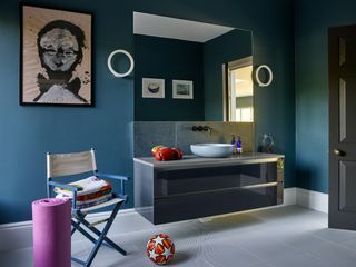 Blue bathroom with circular wall lighting