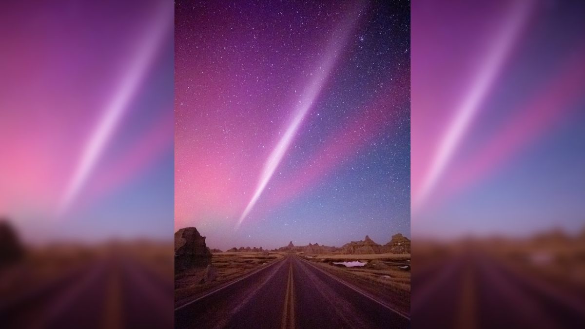 the night sky is lit in a strange glow of purples, pinks, and reds