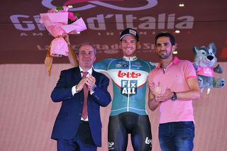 Lotto's Adam Hansen is congratulated by Giro boss Mauro Vegni and former pro Alberto Contador having completed his 20th Grand Tour in a row
