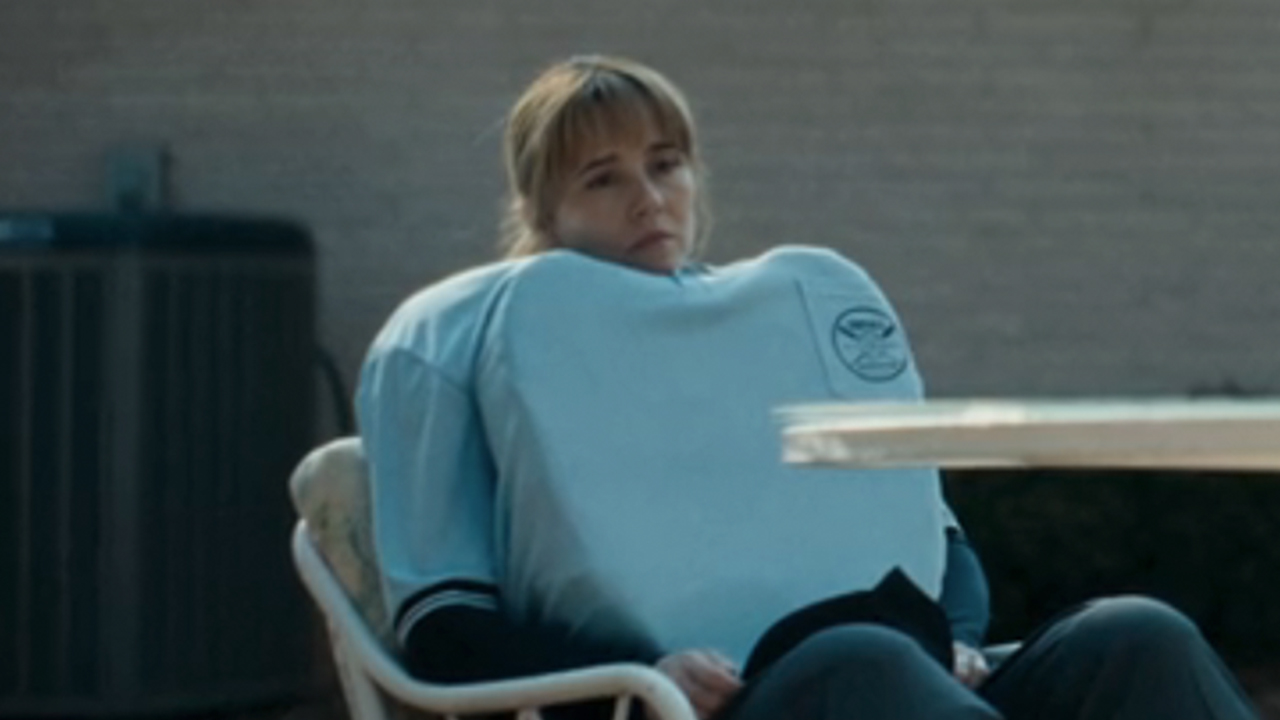 Linda Carellini in her umpire gear, looking sad in DTF St. Louis