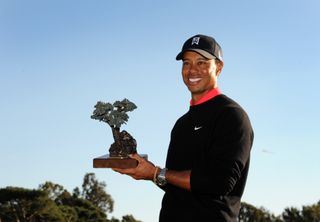 Tiger Woods holds the Farmers Insurance Open trophy