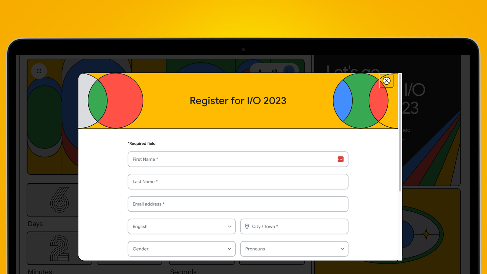 A laptop screen on an orange background showing the registration page for Google IO 2023