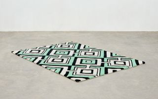 green and black geometric rug