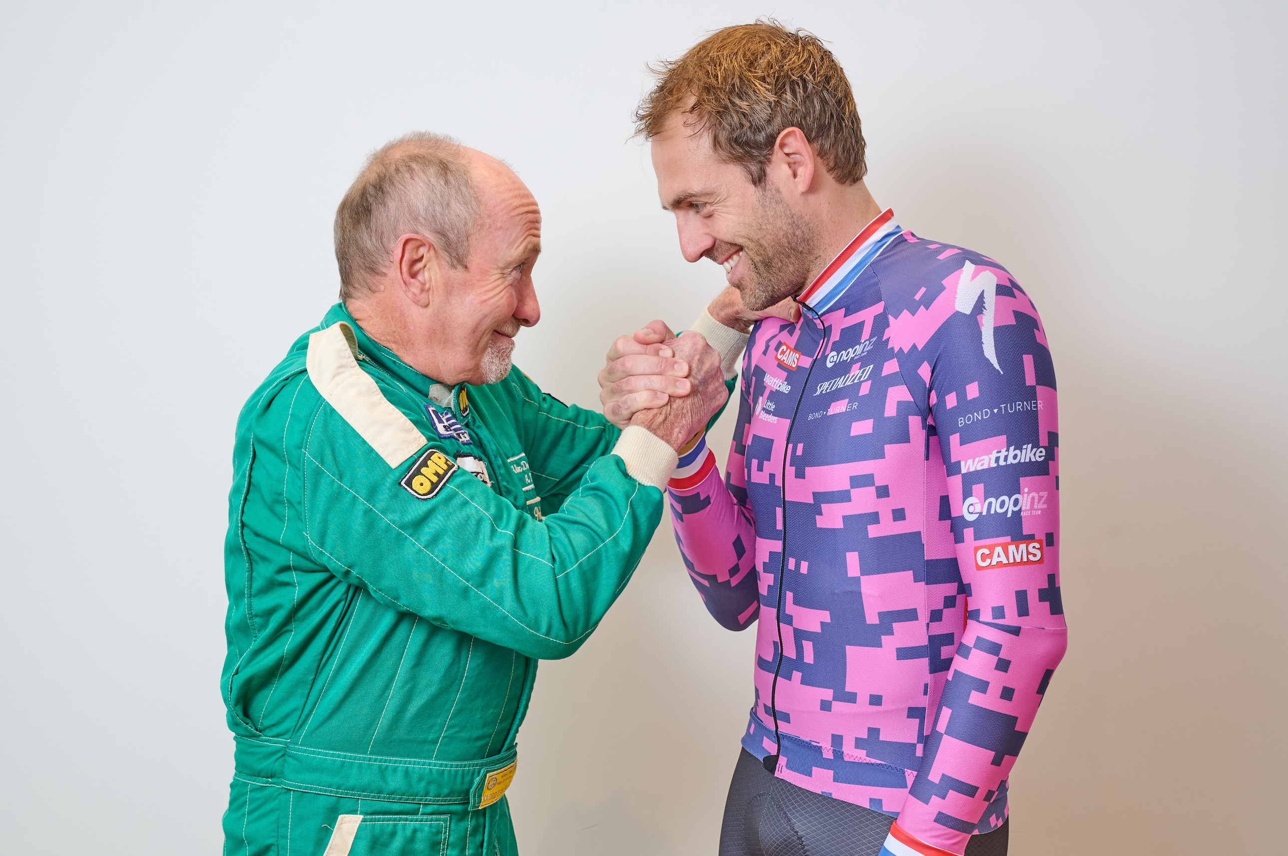 Alex Dowsett standing with his dad, clenching the other&#039;s fist in an arm-wrestle play-fight