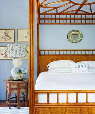 A teenage girl bedroom idea with pale blue walls and bamboo four poster bed