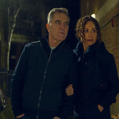 james nesbitt as simon and minnie driver as ingrid wearing all black sneaking around a building investigating in a scene from harlan coben's run away