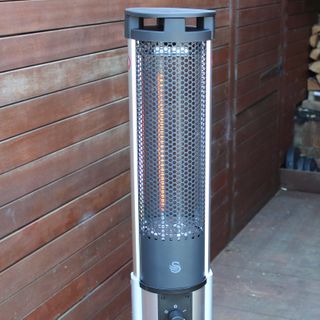 The Swan Column patio heater with one element lit