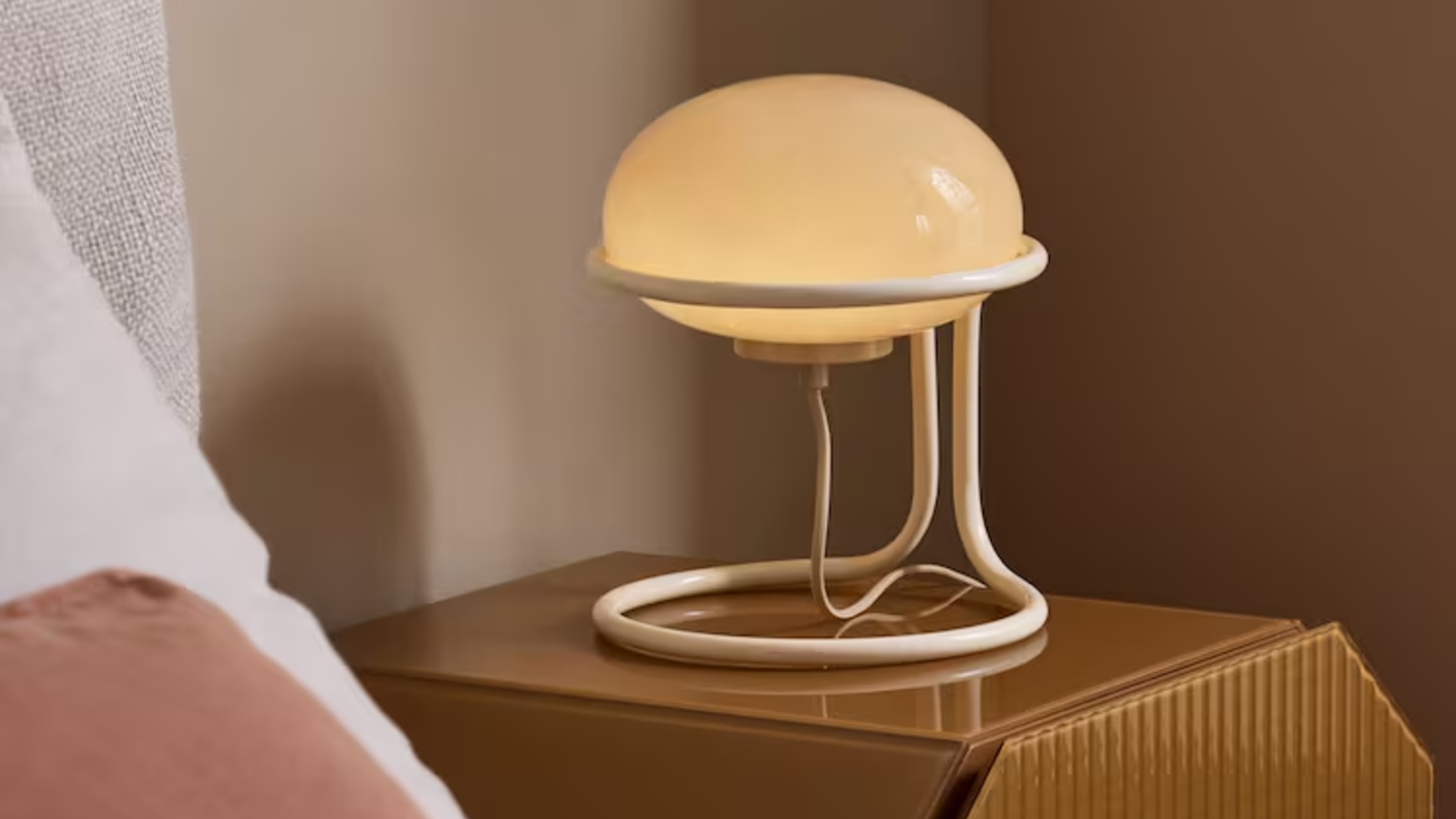 MADE's Piper Table Lamp in Cream on a bedside table