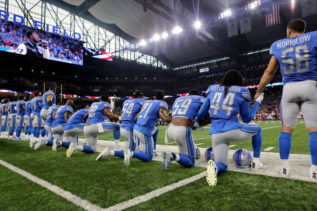 NFL players kneeling. 