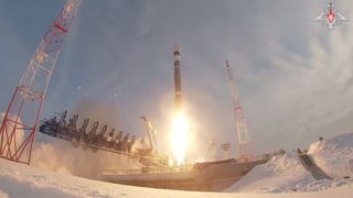 a rocket launches from a launch pad in a snow-covered landscape