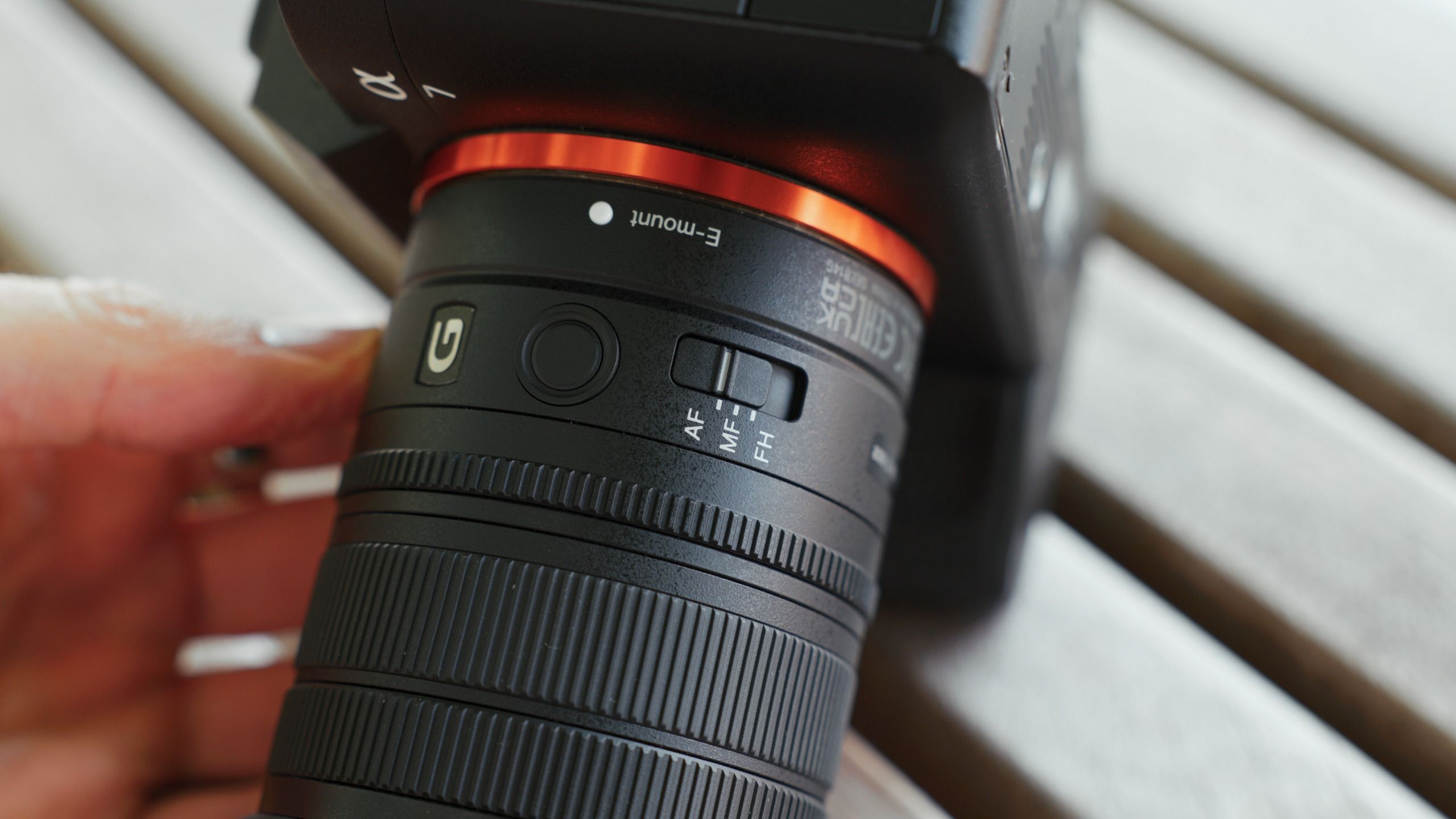 Close-up of the AF, MF and focus hold controls on the Sony FE 8-14mm F3.5 G lens mounted on a Sony camera.