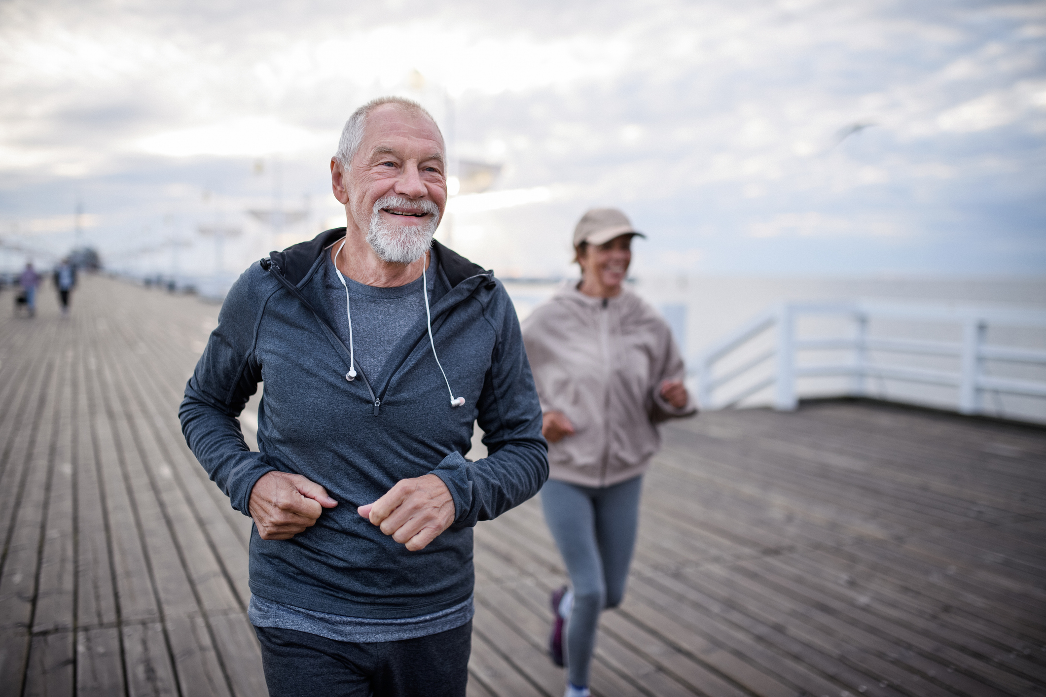 Older couple jogging on the boardwalk