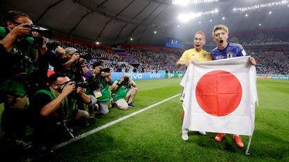 Japan’s Yuto Nagatomo and Ritsu Doan celebrate beating Spain 