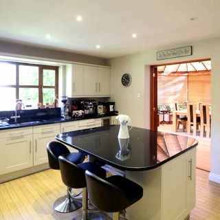 kitchen room with granite worktop and flower jug with black chair