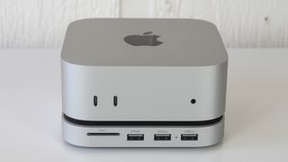 The Mac mini M4 on a table with Satechi's new USB-C hub and stand underneath it