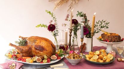A picture of one of the best Christmas turkeys for 2021 on a table surrounded by festive fare and decorations