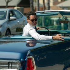 Manuel Garcia-Rulfo as Mickey Haller, looking back from the driver's seat of a convertible Lincoln, in episode 303 of The Lincoln Lawyer.