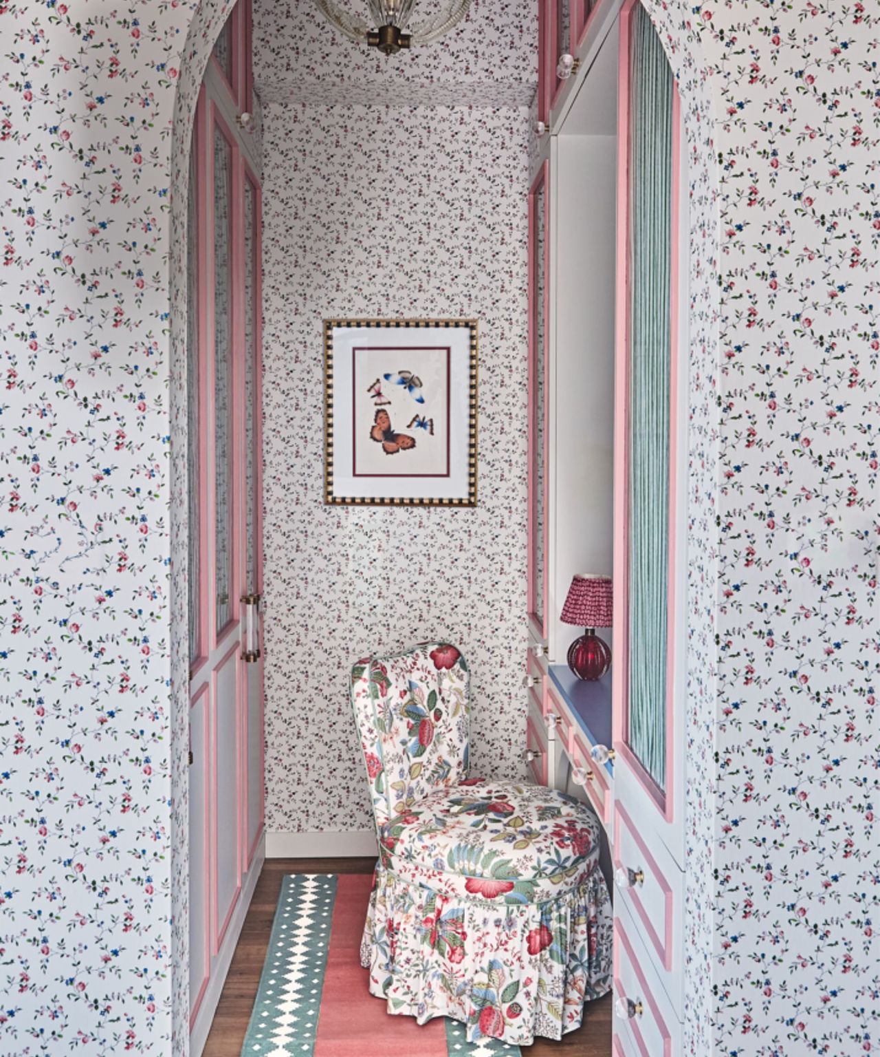 floral master bedroom with a four poster bed and a small dressing room