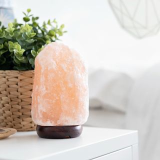 Salt lamp placed on table in bedroom