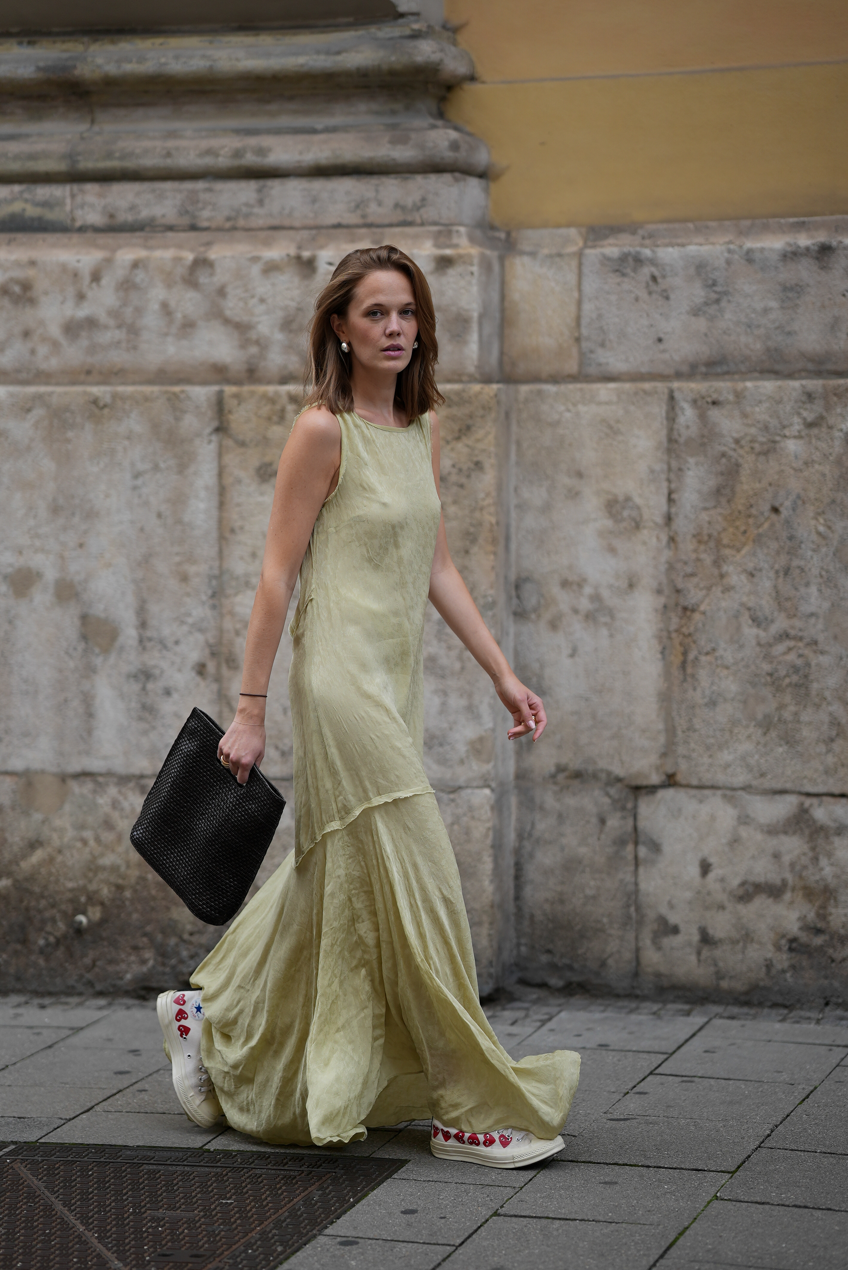 Pia Riegel is seen wearing an olive green Zara dress, silver H&amp;amp;M earrings; Pomellato and LRR Studios rings, a black squared weaved COS handbag, and a pair of white Converse x Comme des Gar&amp;ccedil;ons sneakers.